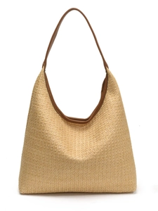 Large beige woven straw tote bag with brown leather straps for summer beach vacations
