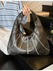 Elegant black large capacity hobo tote bag with vertical stitching and wide handle strap