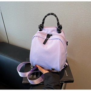 Close-up of a light purple waterproof nylon mini backpack with thick woven rope handles