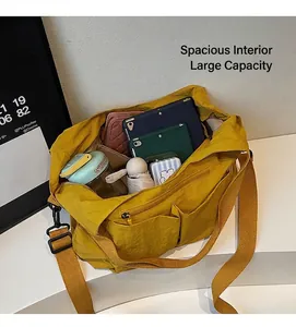 Top view of spacious bright yellow nylon tote bag interior with tablet and umbrella