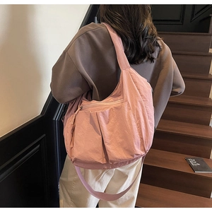 Pink large-capacity nylon tote bag featuring front zipper pockets and wide shoulder strap