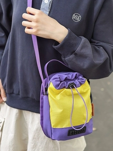 Mini nylon bucket bag with purple and yellow color blocking and drawstring closure
