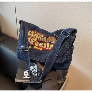 Detail of vintage denim tote bag featuring retro 'Lookin' Good' embroidery and texture