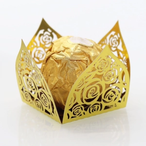 Detail of laser-cut gold rose pattern paper chocolate wrapper with hollow design