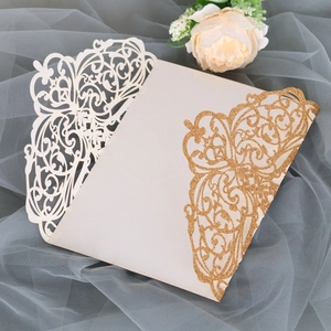 Detailed laser-cut wedding invitation sleeve with beige floral patterns and gold glitter