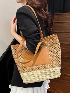 Large woven straw tote bag with dual-tone color blocking and brown leather handles