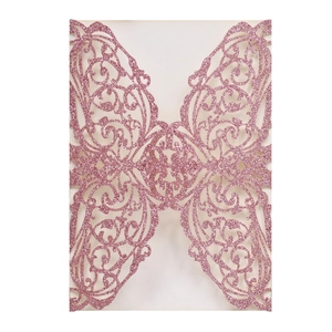 Detailed laser-cut pattern on pink glitter paper for wedding invitation cover