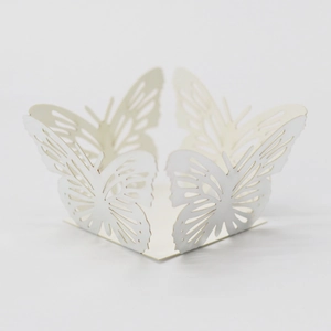 Macro shot of laser-cut cream paper butterfly holder with intricate hollow patterns
