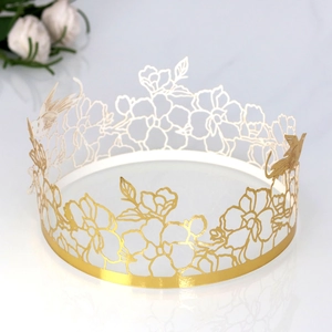 Detailed laser-cut gold mirror cake border with intricate flower and bird patterns