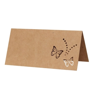 Brown kraft paper tent card with laser-cut butterfly design for wedding table settings