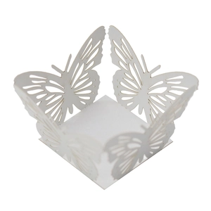 Detail view of laser-cut white butterfly paper favor box for weddings and parties