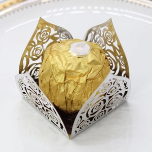 Close-up of laser-cut hollow rose pattern candy box with silver mirror finish