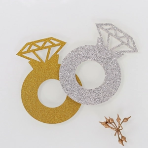 Close-up of sparkling gold and silver glitter diamond ring shape place cards for party