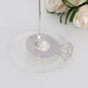 Close-up of silver glitter diamond ring place card on a glass for wedding decor