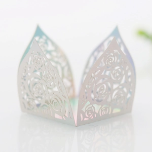 Macro shot of laser-cut rose patterns on premium pearlescent paper with iridescent glow