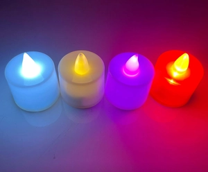 Set of four LED tea light candles in blue, warm white, purple, and red for film night ambiance
