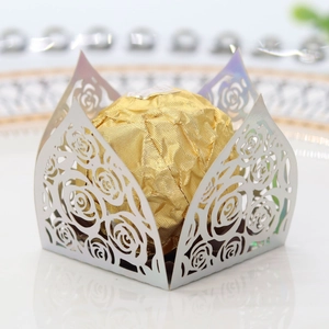 Macro shot of silver hollow rose laser-cut chocolate wrapper holder with gold candy