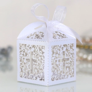 Laser-cut white favor box with intricate floral patterns and ribbon for baptisms