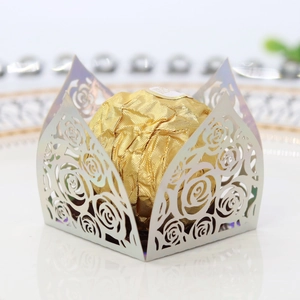 Macro shot of silver hollow-out rose paper wrappers with shiny metallic finish for candy