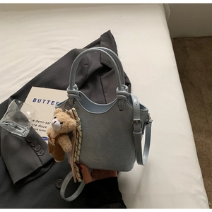 Light blue faux crocodile bucket bag with cute bear charm and decorative scarf strap