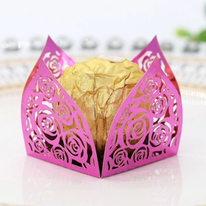 Close-up of laser-cut rose pattern magenta paper chocolate wrapper for parties