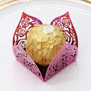 Macro detail of laser-cut rose hollow chocolate decorative tray in magenta metallic paper
