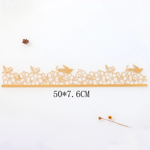 Macro view of golden laser-cut cake border with rose and bird lace pattern, 50x7.6cm