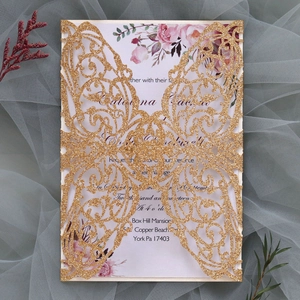 Detail of laser-cut glitter butterfly wedding invitation with elegant floral insert