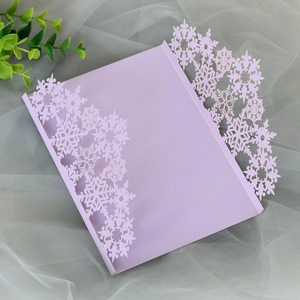 Detailed laser cut lavender snowflake invitation card with intricate hollowed patterns