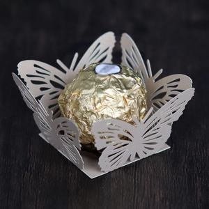 Detail of laser-cut butterfly wrapper for chocolate with elegant lace texture