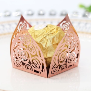 Macro detail of rose gold laser-cut hollow rose pattern candy and chocolate box