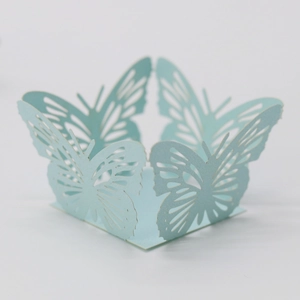 Detail of light blue laser-cut butterfly pattern cupcake wrappers for wedding parties