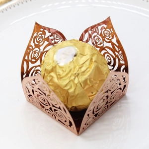 Close-up of laser-cut rose gold hollowed flower wrapper for chocolates and candies