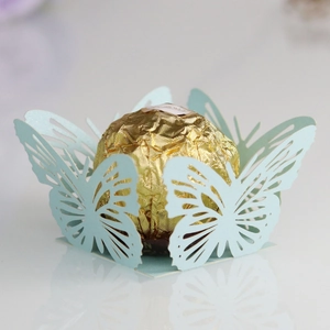 Detail of light blue laser-cut butterfly chocolate paper wrapper with intricate patterns