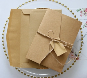 Macro shot of rustic kraft paper wedding invitation set with twine and a small tag