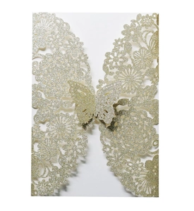 Macro shot of gold glitter laser-cut floral wedding invitation with 3D butterfly detail