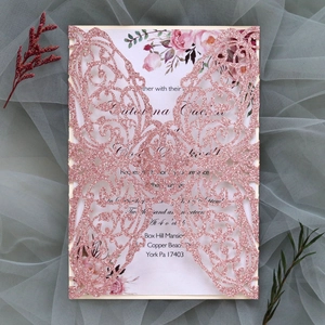 Detailed laser-cut wedding invitation with rose gold glitter and elegant floral inner card