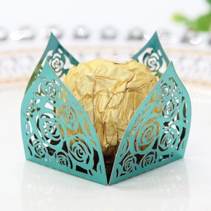 Detailed view of teal laser-cut rose hollow favor box with golden chocolate