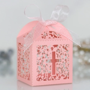 Detailed laser-cut pink gift box with floral cross patterns and white chiffon ribbon