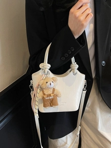 White crocodile embossed bucket bag with cute bear charm and knotted handle design