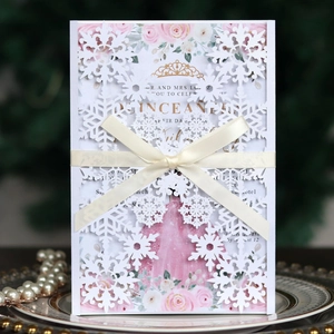 Laser-cut snowflake invitation with cream ribbon and Quinceañera floral insert card