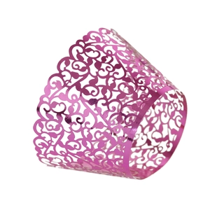 Macro detail of laser-cut floral pattern on metallic pink cupcake wrappers for party decor