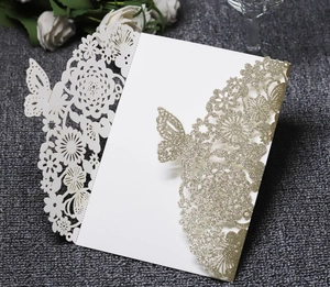 Detailed laser-cut wedding invitation featuring gold glitter floral hollows and 3D butterflies