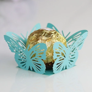 Intricate laser-cut butterfly cupcake wrapper in mint green for wedding chocolate decor