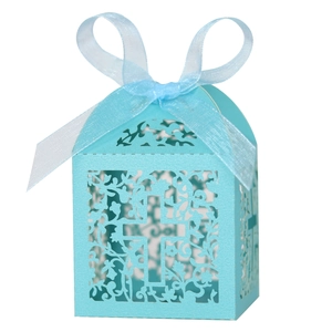 Detail of light blue laser-cut wedding favor box with cross pattern and silk ribbon bow