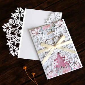 Laser cut white snowflake invitation card with pink floral inner page and white silk bow