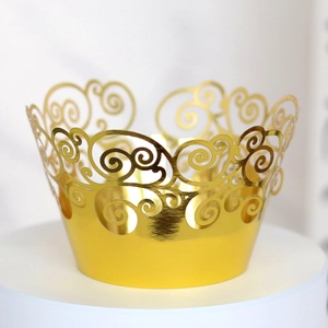 Macro view of gold laser-cut hollow cake wrapper with intricate scroll patterns