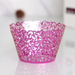 Detail showing laser-cut rose red cupcake wrapper with intricate vine hollow patterns
