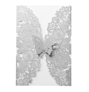 Detailed silver glitter butterfly invitation card with intricate laser-cut floral patterns