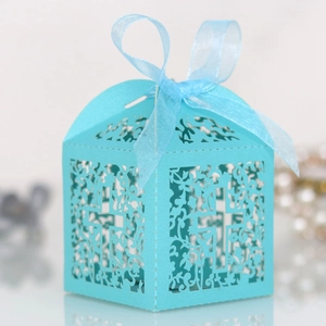 Detailed laser-cut light blue wedding candy box featuring a hollow cross design and ribbon
